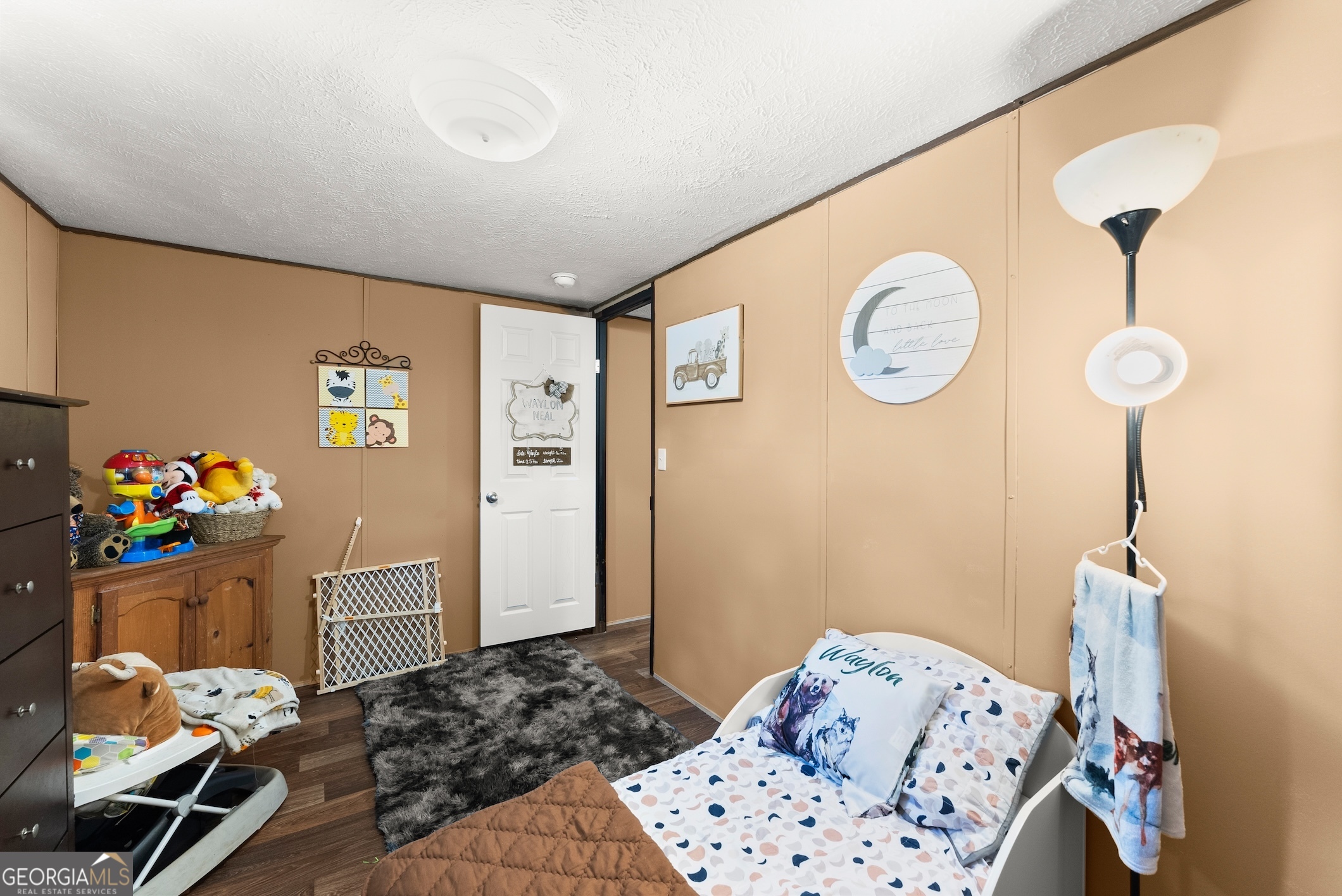 303 Blakely Chappelear Road Martin, GA 30557 - Photo 10 of 20 a bedroom with a bed and a chandelier