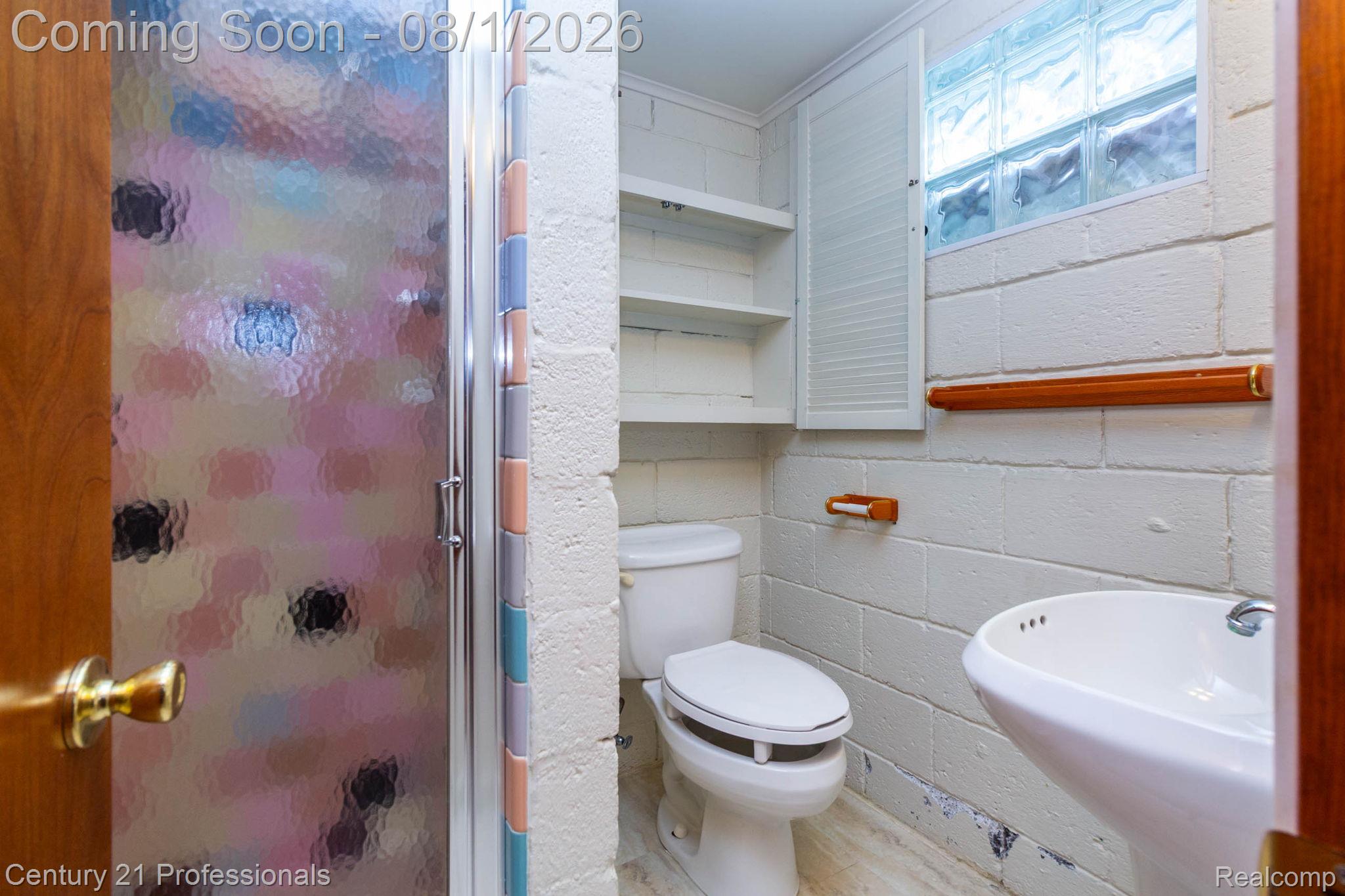 1365 East Buell Road Rochester, MI 48306 - Photo 30 of 56 Bathroom featuring a standalone shower with frosted glass enclosure, pedestal sink, and toilet
