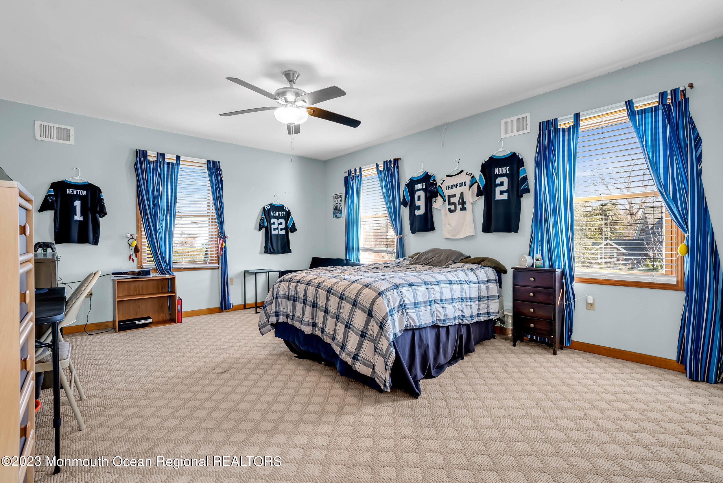 250 Cliftwood Road Oakhurst, NJ 07755 - Photo 12 of 40 a bedroom with a large bed and a chandelier