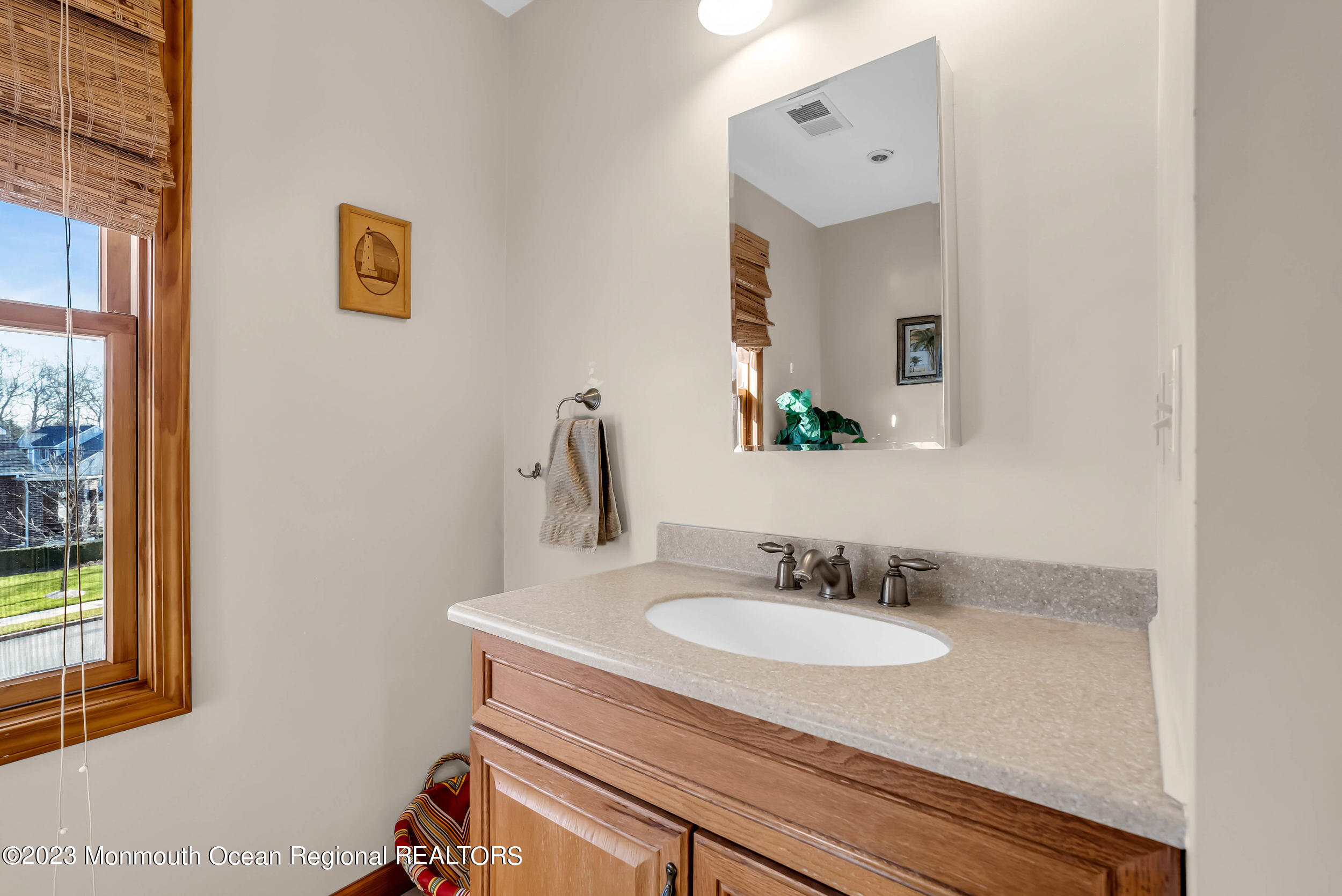 250 Cliftwood Road Oakhurst, NJ 07755 - Photo 17 of 40 a bathroom with a granite countertop sink and a mirror