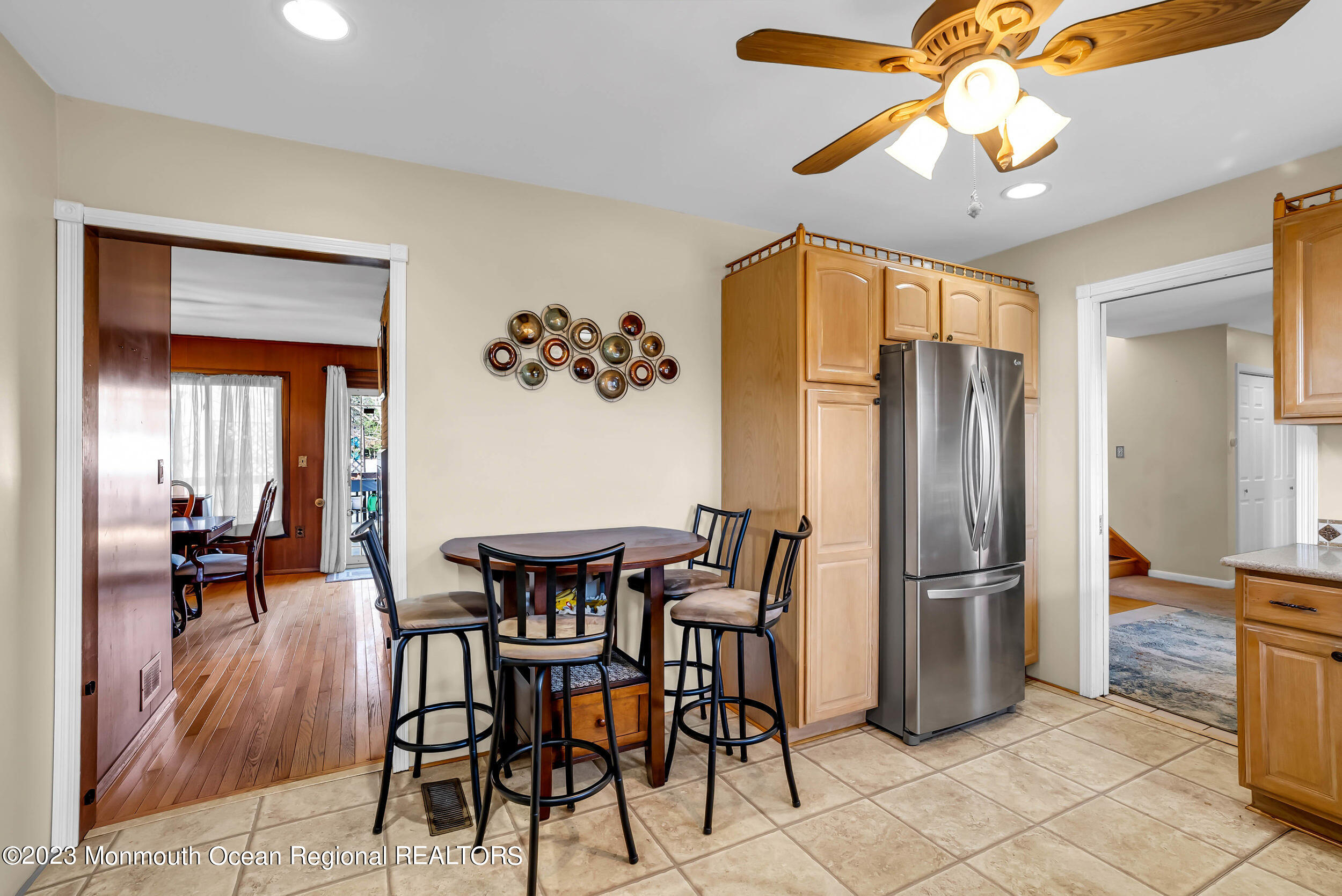 250 Cliftwood Road Oakhurst, NJ 07755 - Photo 30 of 40 a dining room with chandelier fan and wooden floor