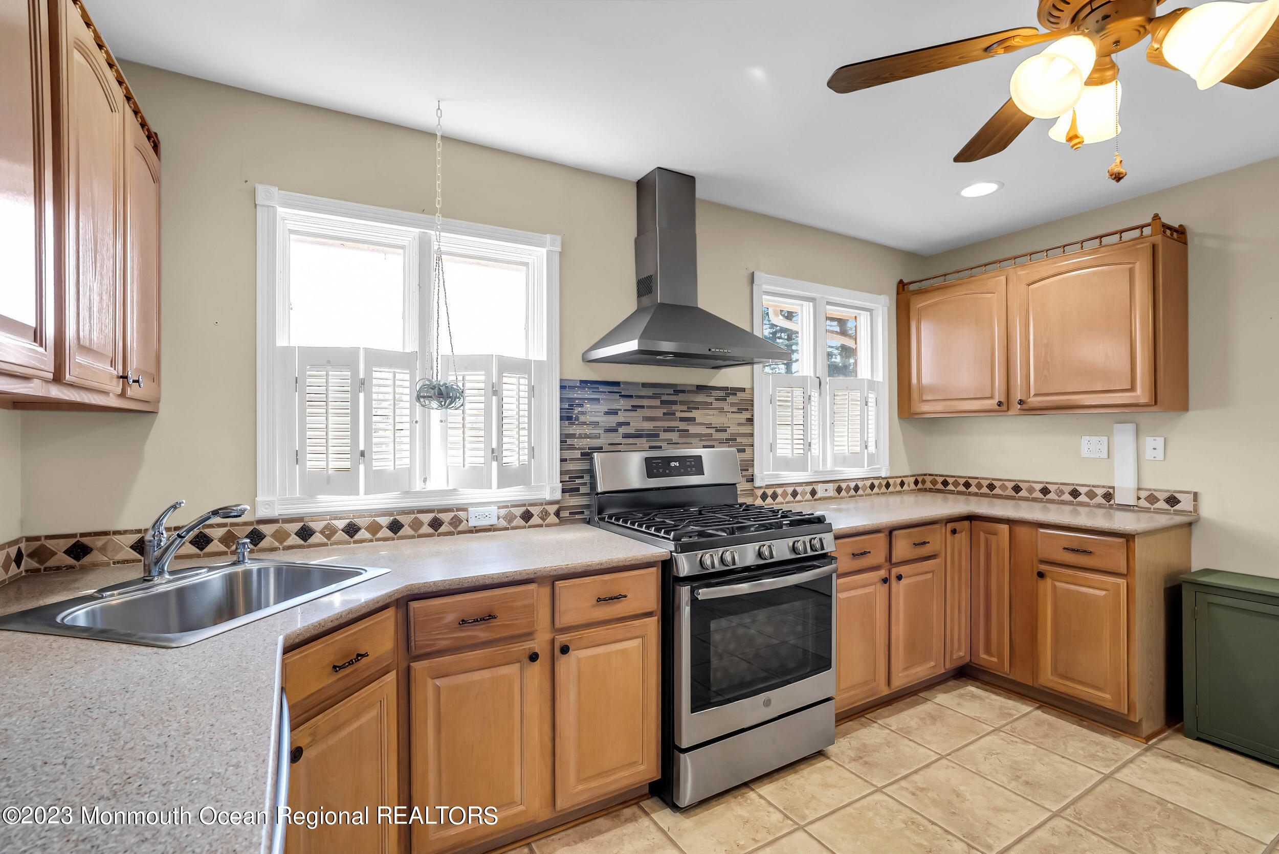 250 Cliftwood Road Oakhurst, NJ 07755 - Photo 31 of 40 a kitchen with stainless steel appliances granite countertop a sink stove cabinets and a window