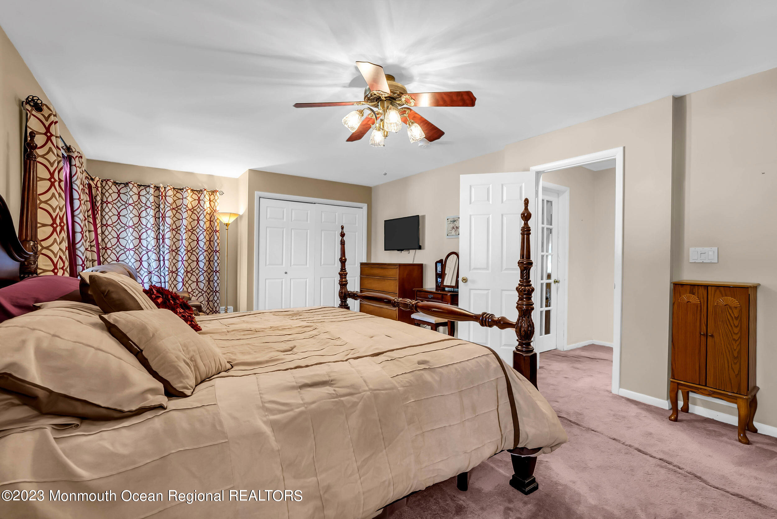 250 Cliftwood Road Oakhurst, NJ 07755 - Photo 33 of 40 a bedroom with a bed and a chandelier