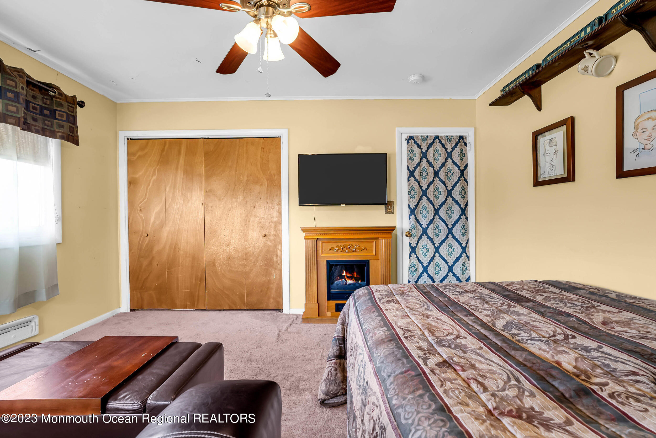 250 Cliftwood Road Oakhurst, NJ 07755 - Photo 34 of 40 a bedroom with a bed and a fireplace