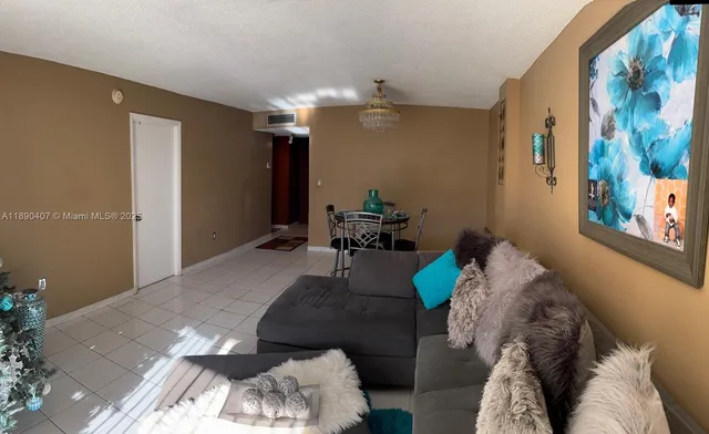 a living room with furniture and a chandelier