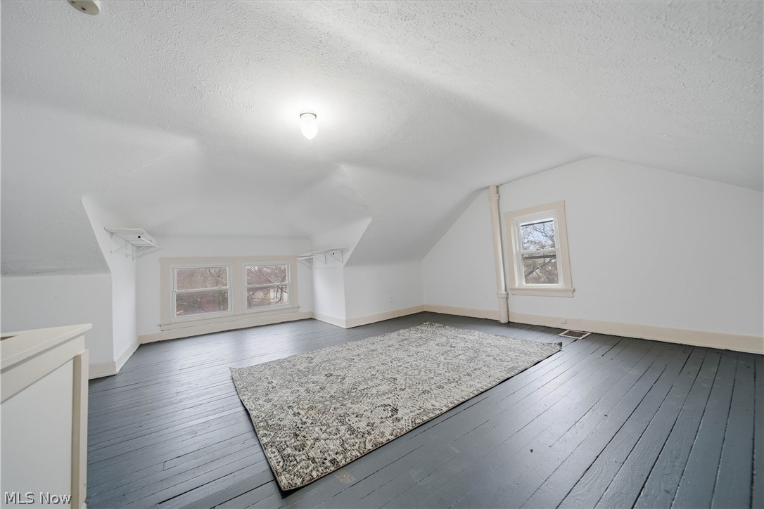 225 Cranz Place Akron, OH 44310 - Photo 16 of 34 Bonus room with lofted ceiling, a textured ceiling, and wood-type flooring