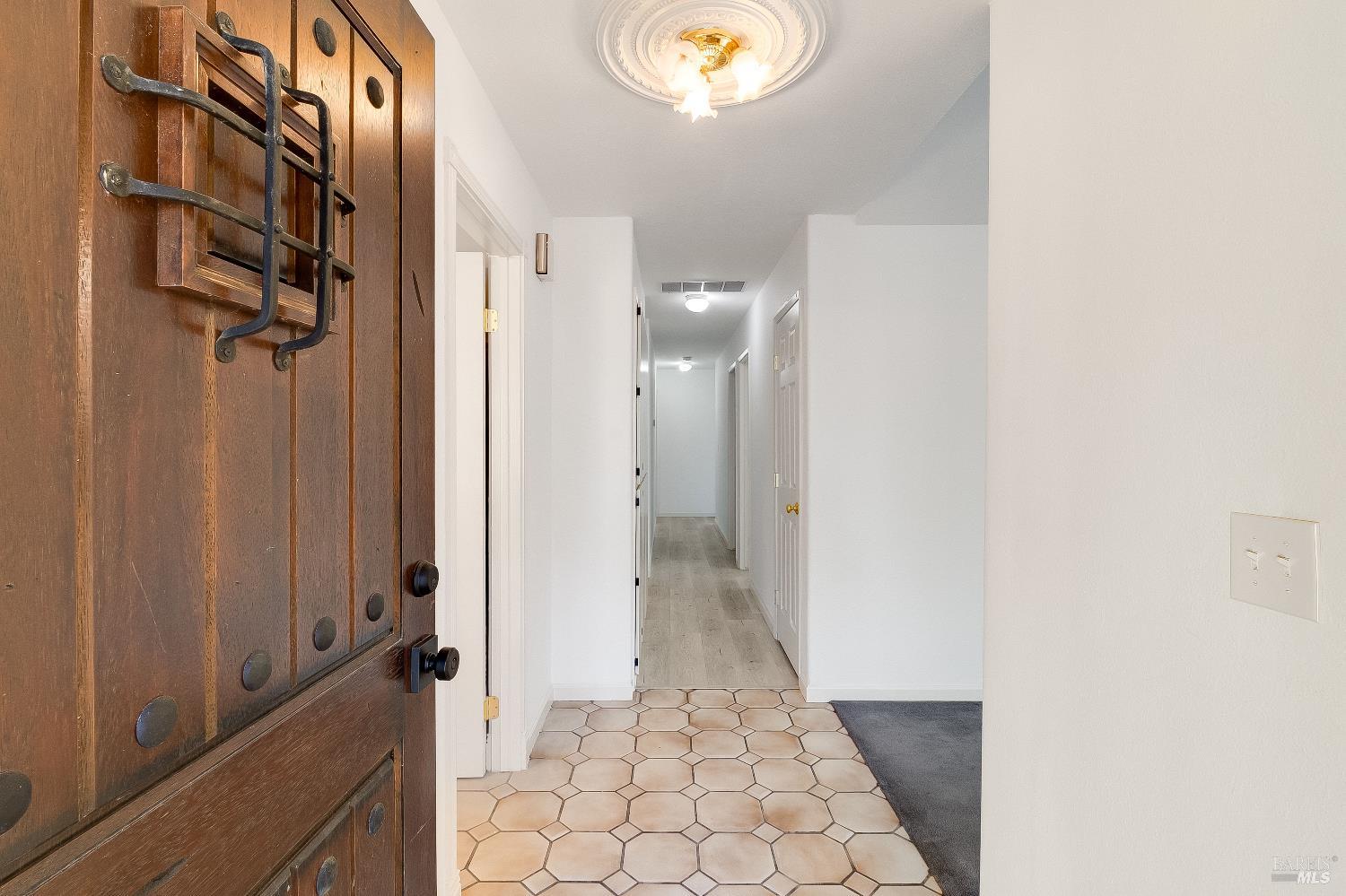 900 Seascape Circle Rodeo, CA 94572 - Photo 19 of 54 a view of a hallway with wooden floor and a bathroom