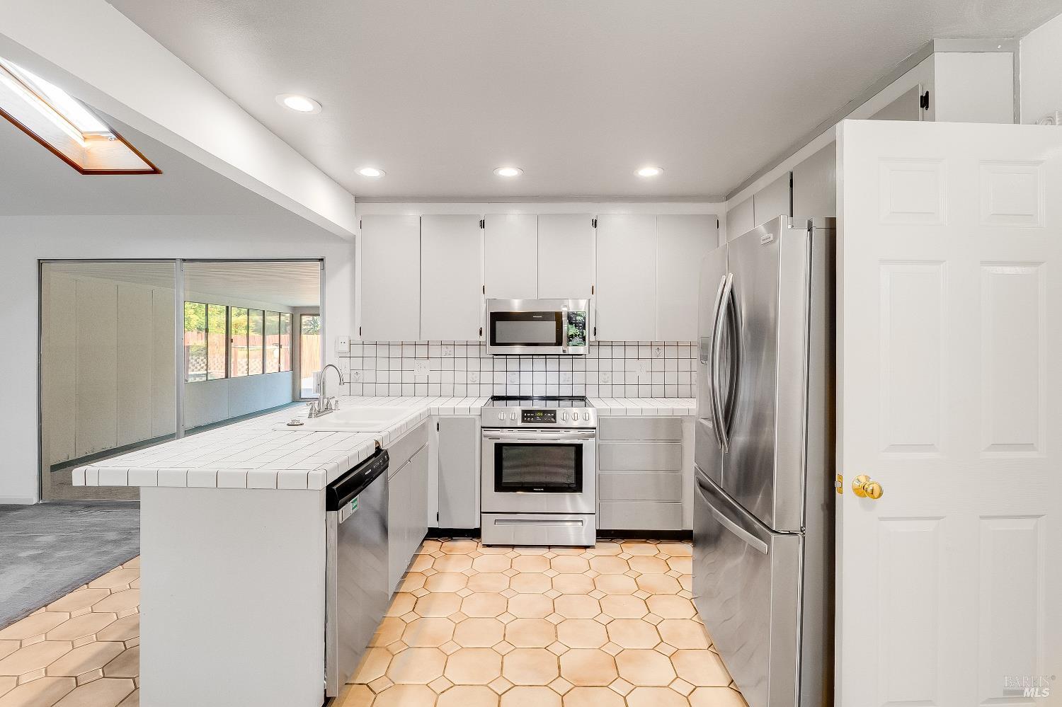 900 Seascape Circle Rodeo, CA 94572 - Photo 22 of 54 a kitchen with stainless steel appliances granite countertop a stove a sink and a refrigerator