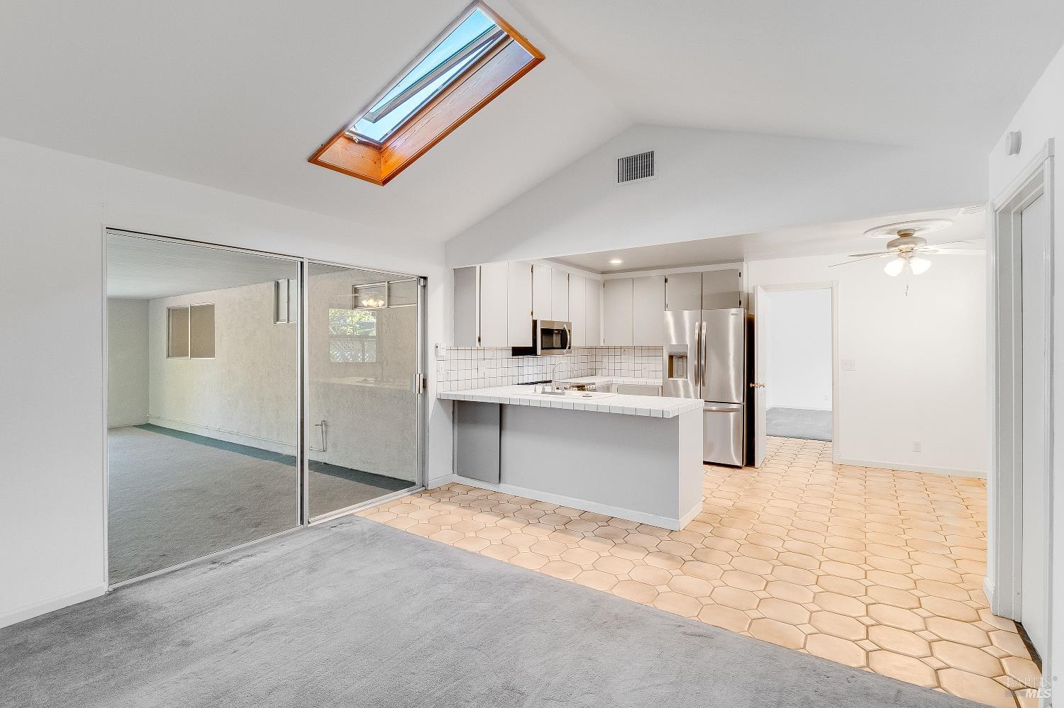 900 Seascape Circle Rodeo, CA 94572 - Photo 24 of 54 a large white kitchen with kitchen island a sink stainless steel appliances and cabinets