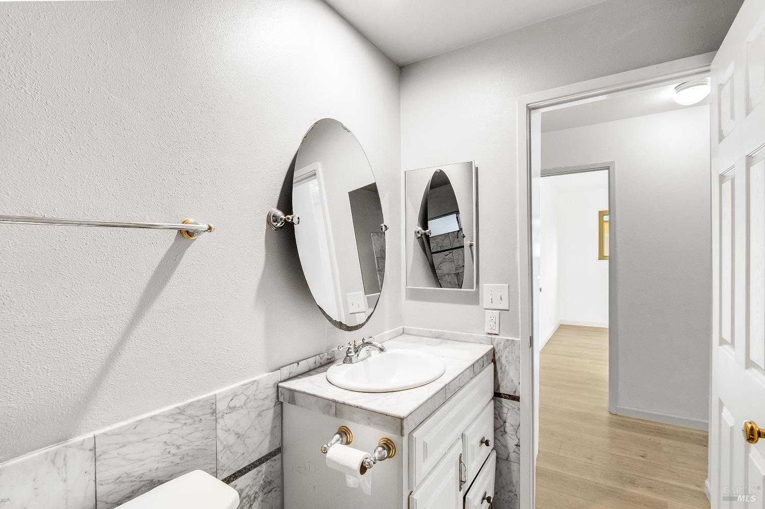 900 Seascape Circle Rodeo, CA 94572 - Photo 30 of 54 a bathroom with a sink a toilet and a mirror