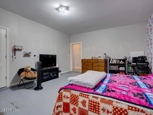 a bedroom with furniture and a flat screen tv