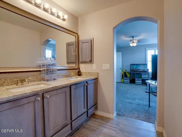 a bathroom with a double vanity sink and a mirror