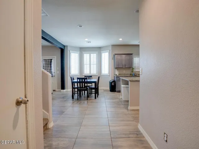 a kitchen with a refrigerator and table