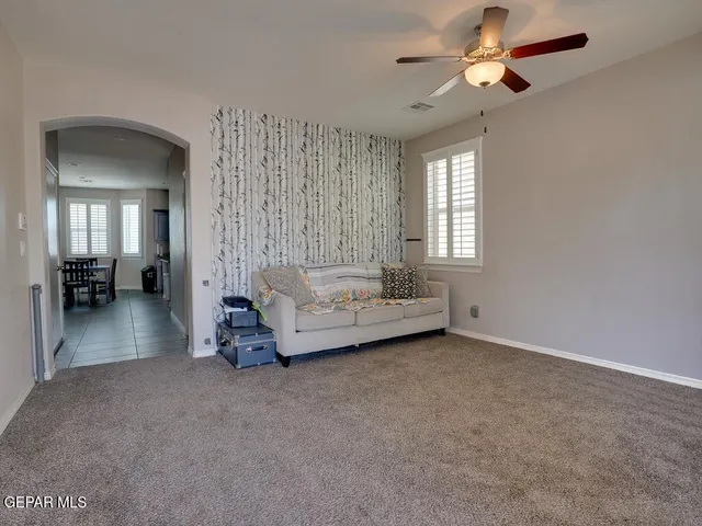 a living room with furniture and a chandelier