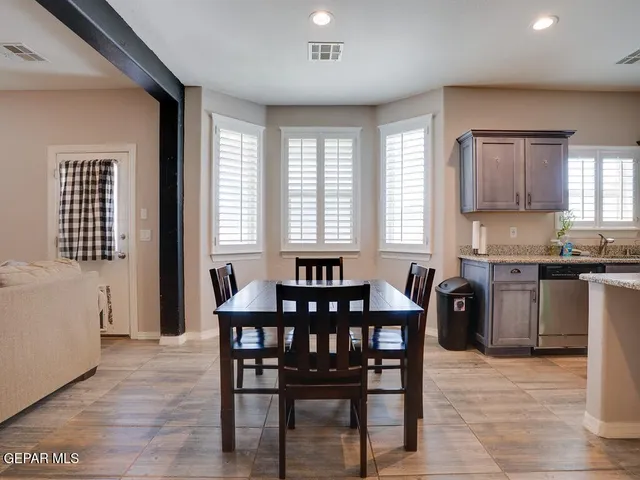 a view of a dining room with furniture and window
