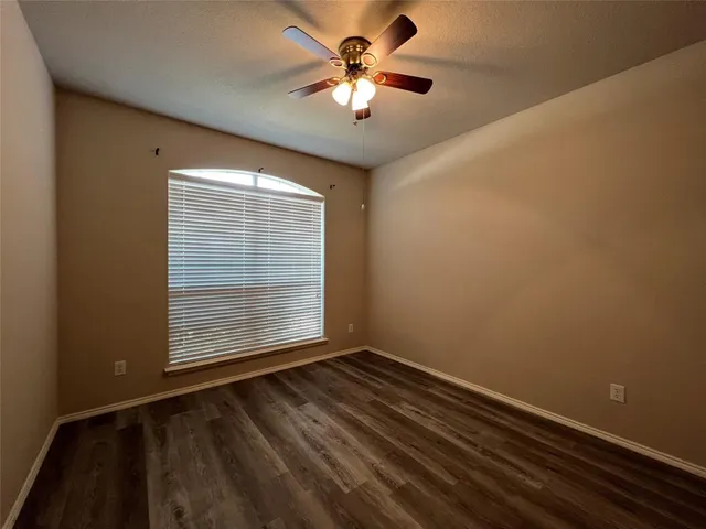 a view of room with window and ceiling fan