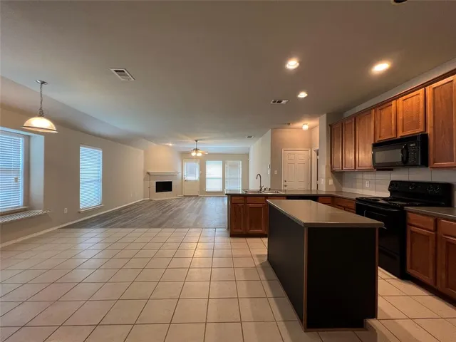 a kitchen with stainless steel appliances granite countertop a sink and a stove