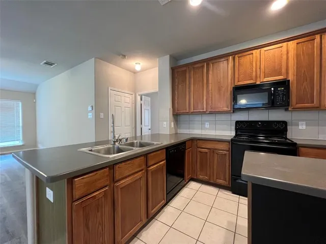 a kitchen with a sink stove top oven and cabinets