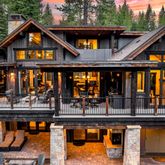a front view of a house with swimming pool and furniture
