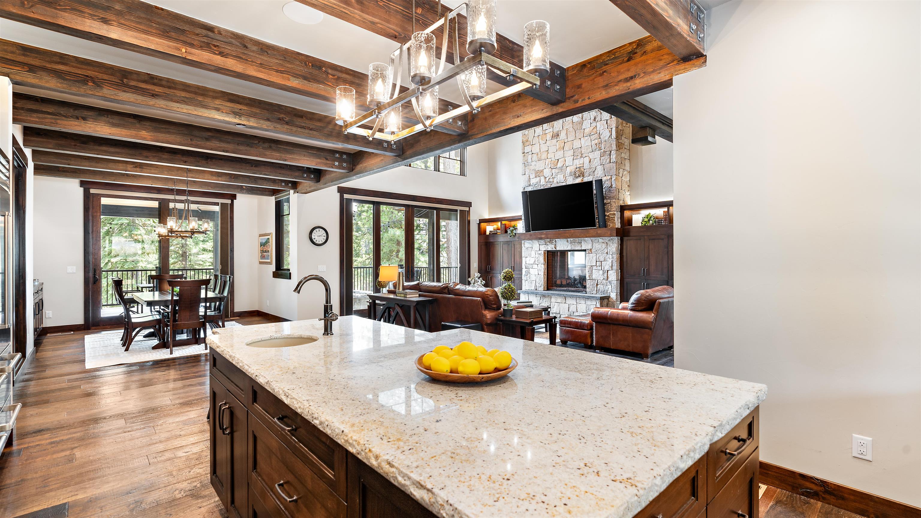 11660 China Camp Road Truckee, CA 96161 - Photo 6 of 21 a view of a dining room and livingroom with furniture wooden floor and a chandelier