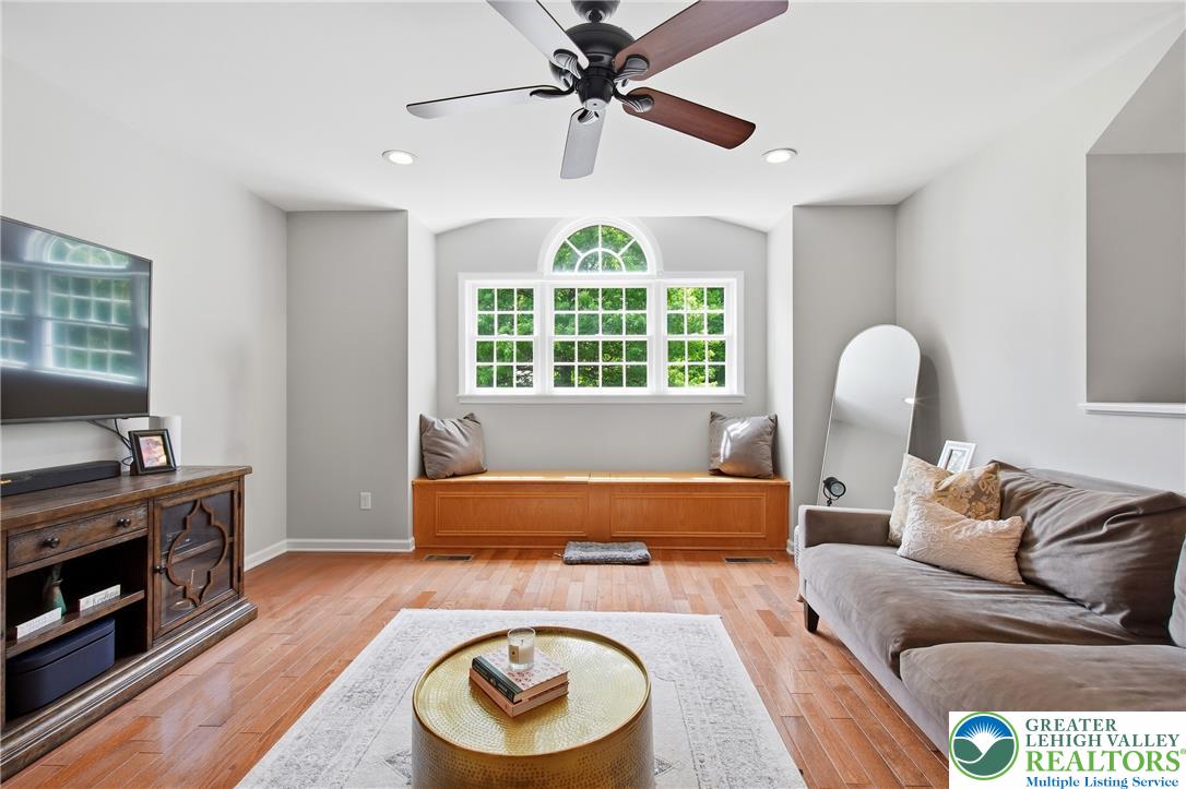 115 West Butternut Road Hellertown, PA 18055 - Photo 40 of 97 Sun-filled family room with hardwood floors and a built-in window seat under a multi-pane window.
