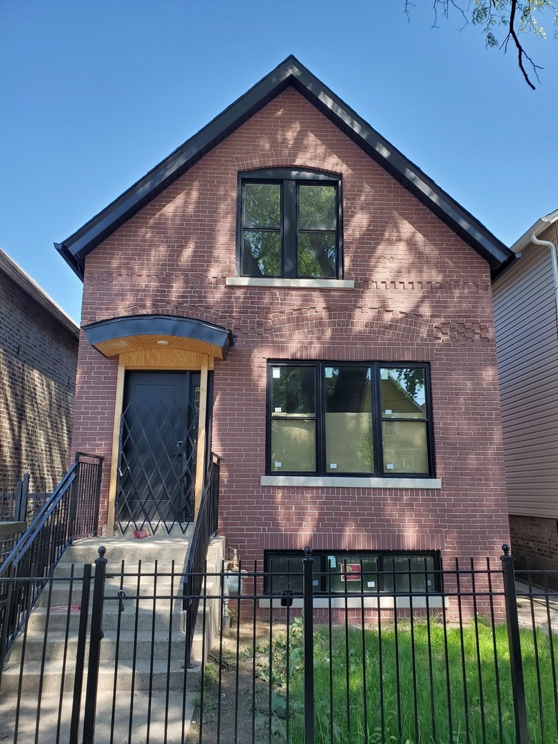 7147 South University Avenue Chicago, IL 60619 - Photo 1 of 25 a front view of a house with a yard