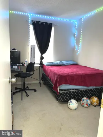 a bed room with a bed and a chair