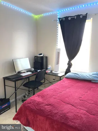 a bedroom with a bed and a potted plant