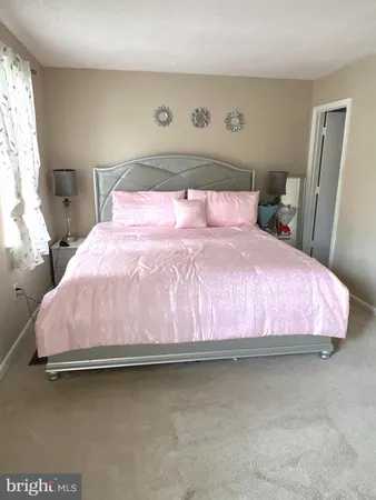 a bedroom with a bed and a table