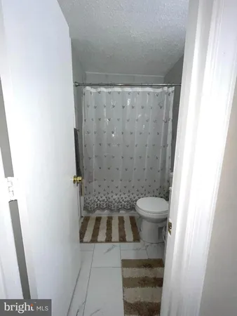a bathroom with a sink a toilet and a shower