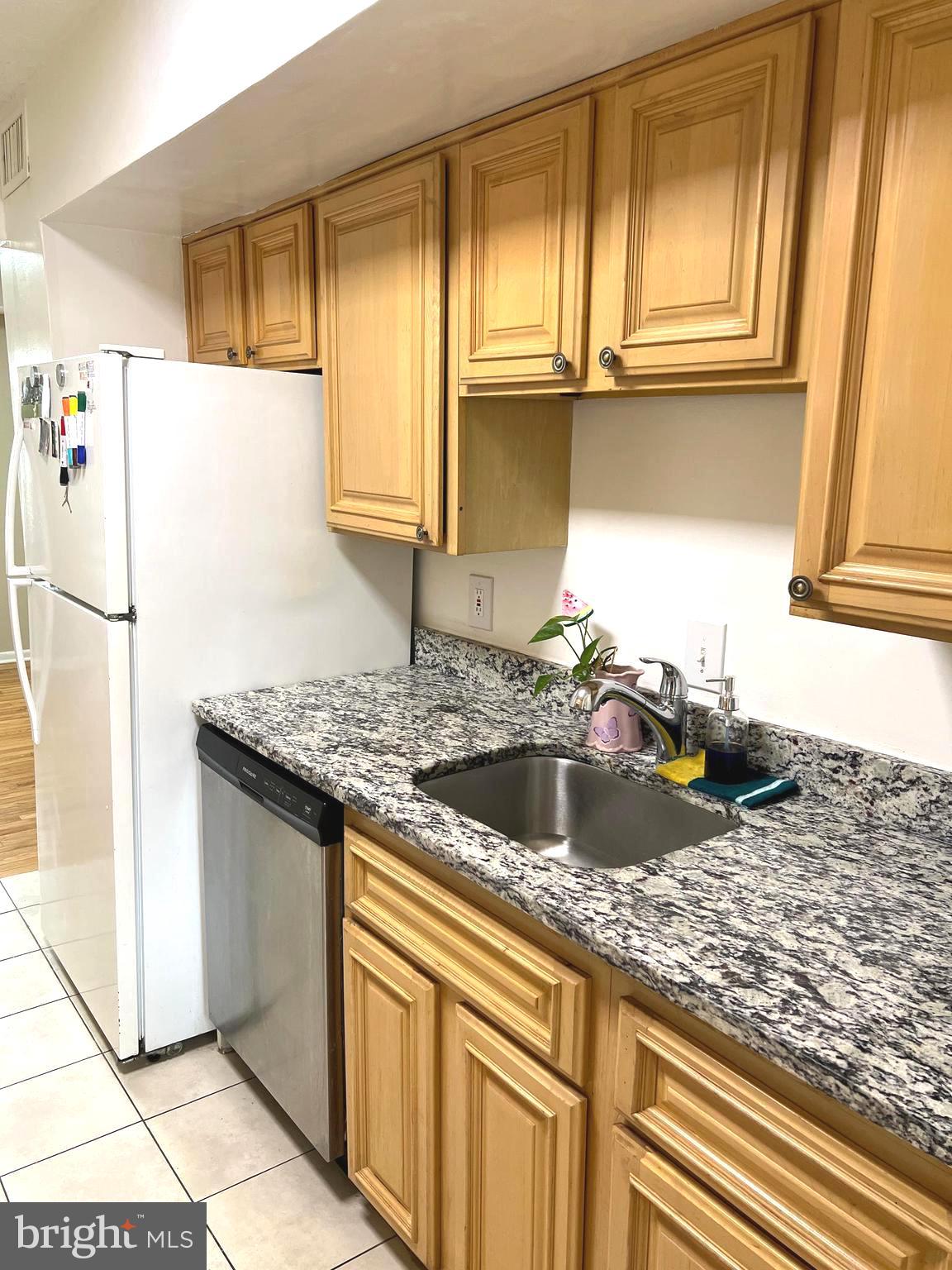 1132 West Side Drive, Unit 32B Gaithersburg, MD 20878 - Photo 10 of 51 a kitchen with a sink a refrigerator and cabinets