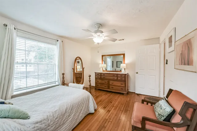 a bedroom with a bed dresser and a window