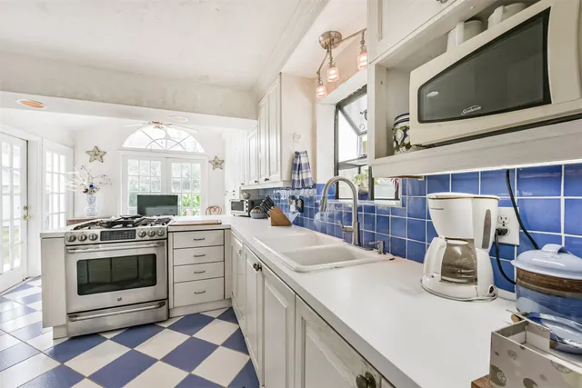 a kitchen with a stove a sink and a microwave