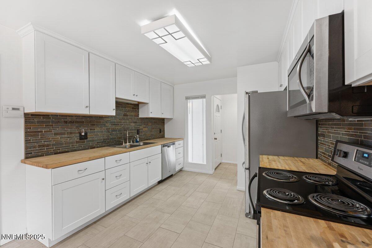 1421 Surf Way Reno, NV 89503 - Photo 12 of 30 a kitchen with granite countertop a stove sink and refrigerator