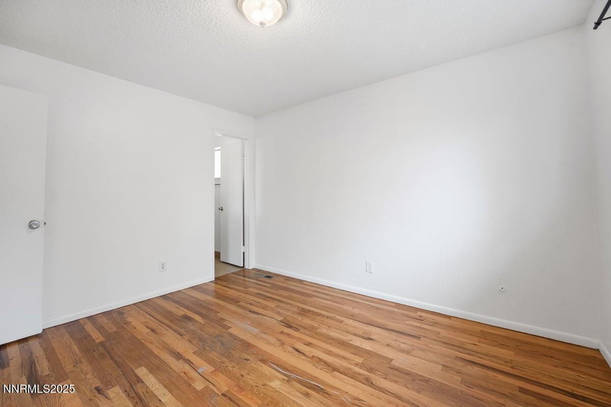 1421 Surf Way Reno, NV 89503 - Photo 18 of 30 a view of empty room with wooden floor