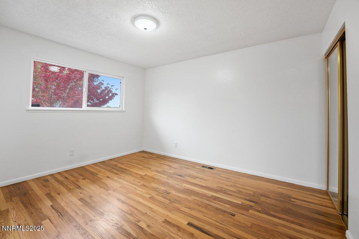 1421 Surf Way Reno, NV 89503 - Photo 20 of 30 an empty room with wooden floor and windows