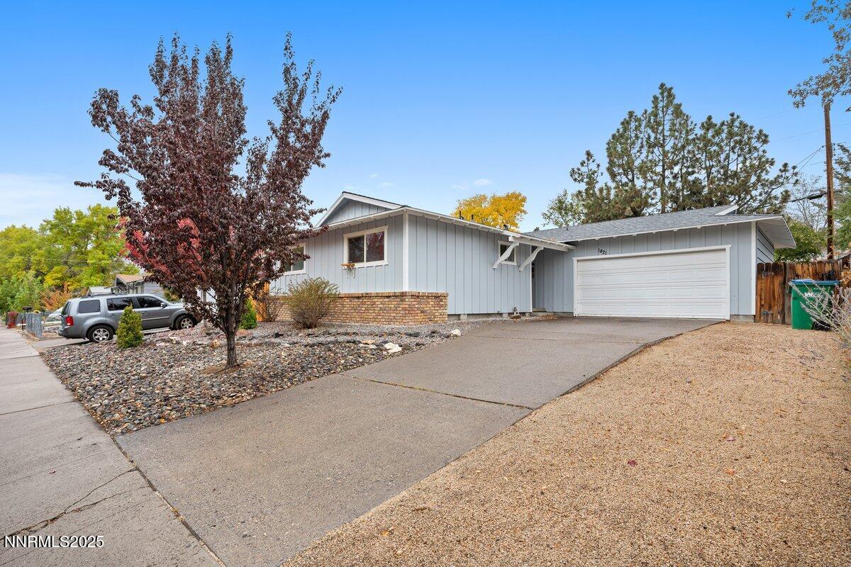1421 Surf Way Reno, NV 89503 - Photo 2 of 30 a front view of a house with a yard and garage