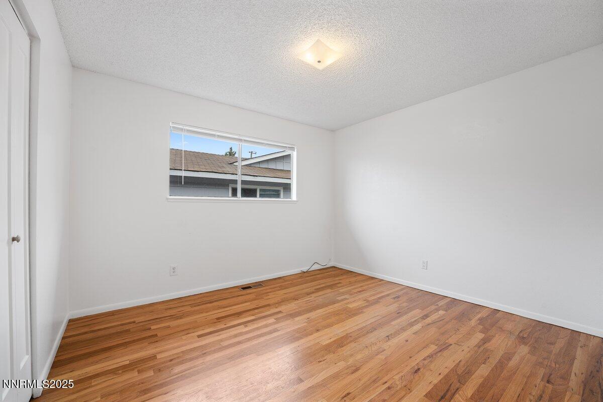 1421 Surf Way Reno, NV 89503 - Photo 23 of 30 a view of empty room with wooden floor