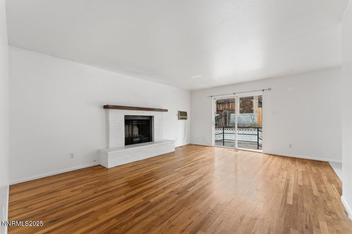 1421 Surf Way Reno, NV 89503 - Photo 4 of 30 a view of empty room with wooden floor and fireplace