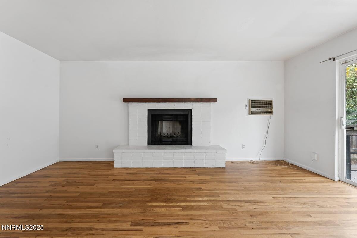 1421 Surf Way Reno, NV 89503 - Photo 5 of 30 a view of empty room with wooden floor and fireplace