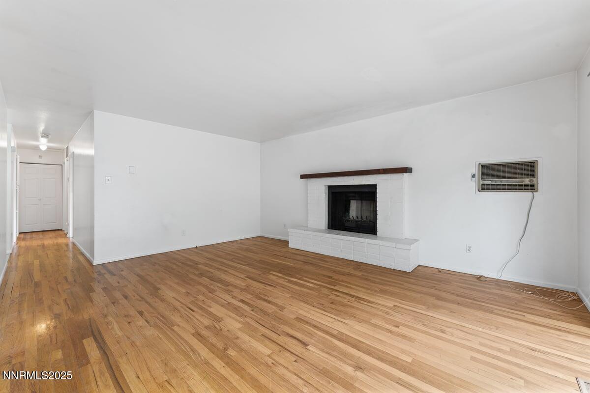 1421 Surf Way Reno, NV 89503 - Photo 6 of 30 a view of empty room with wooden floor and fireplace