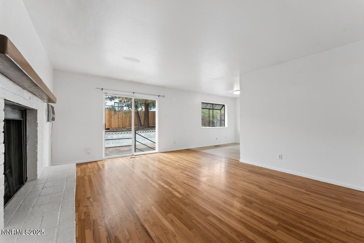 1421 Surf Way Reno, NV 89503 - Photo 9 of 30 a view of an empty room with wooden floor and a window