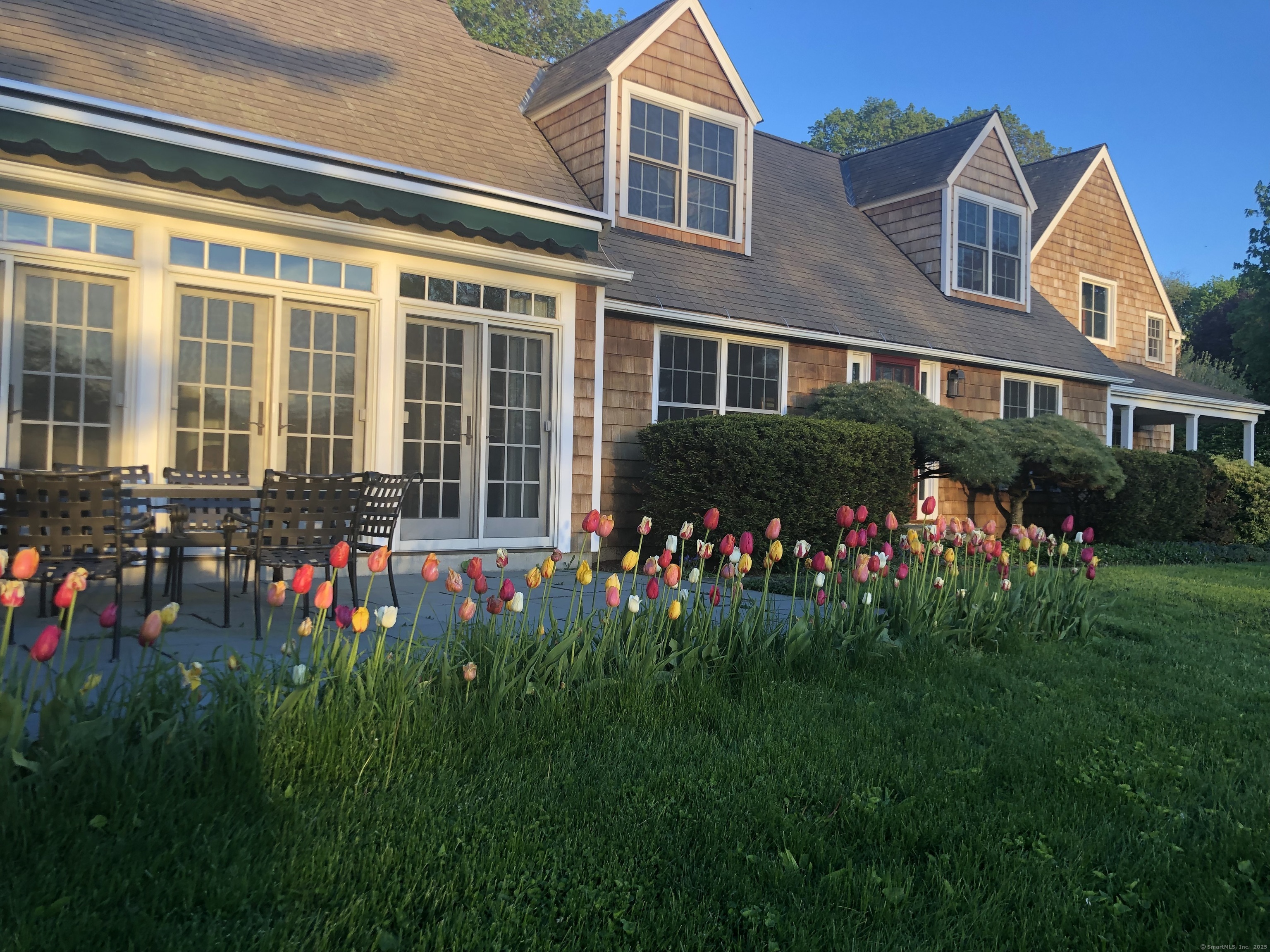 196 Baldwin Hill Road Washington, CT 06777 - Photo 2 of 28 a front view of a house with a big yard and potted plants