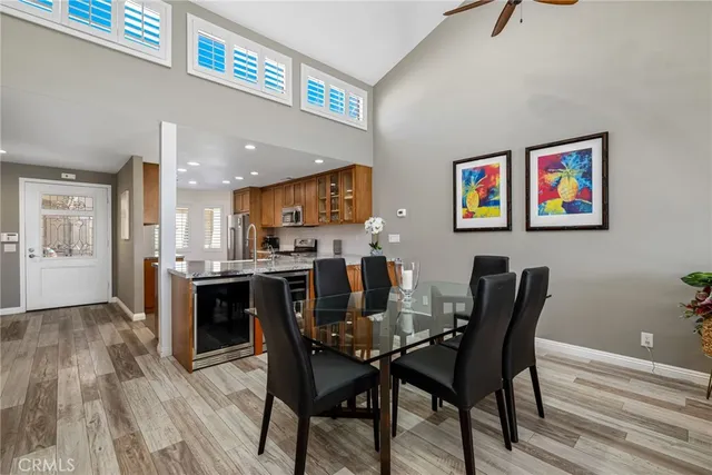a living room with furniture a flat screen tv and a floor to ceiling window