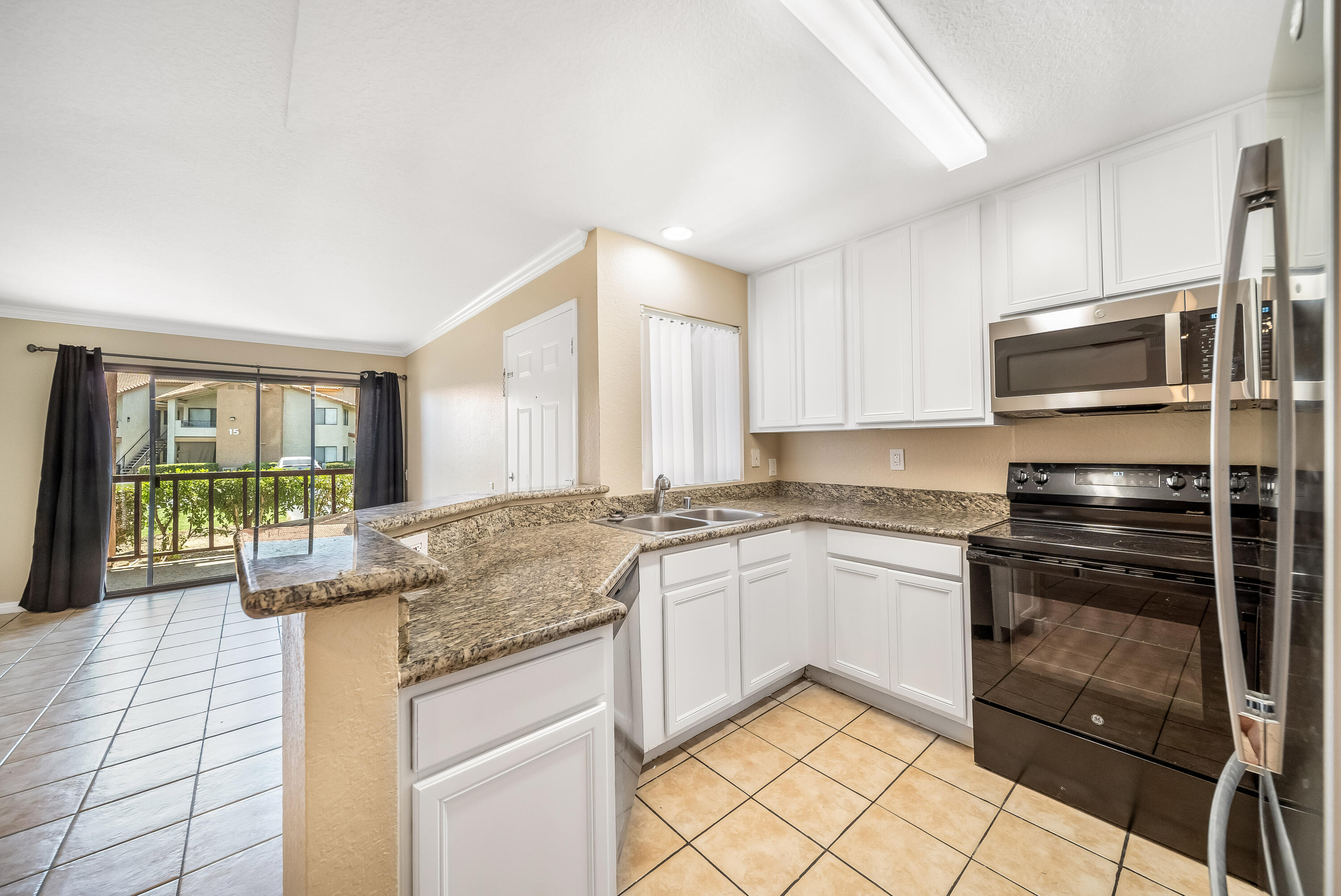 78650 Ave 42, Unit 1407 Bermuda Dunes, CA 92203 - Photo 1 of 20 a kitchen with stainless steel appliances granite countertop a stove a sink and a refrigerator