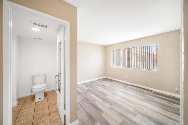 a bathroom with a toilet and a window