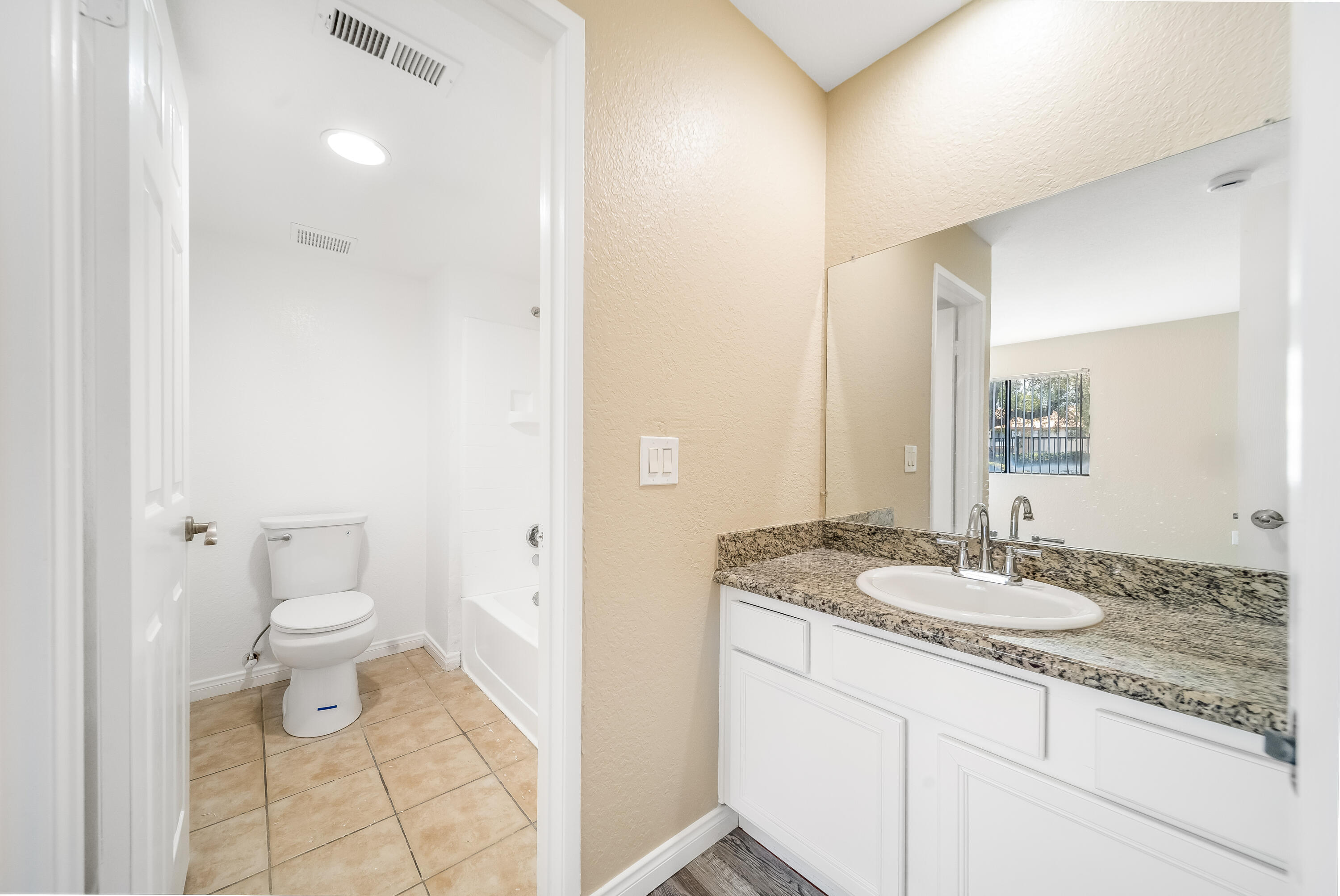 78650 Ave 42, Unit 1407 Bermuda Dunes, CA 92203 - Photo 14 of 20 a bathroom with a granite countertop sink a toilet and a mirror
