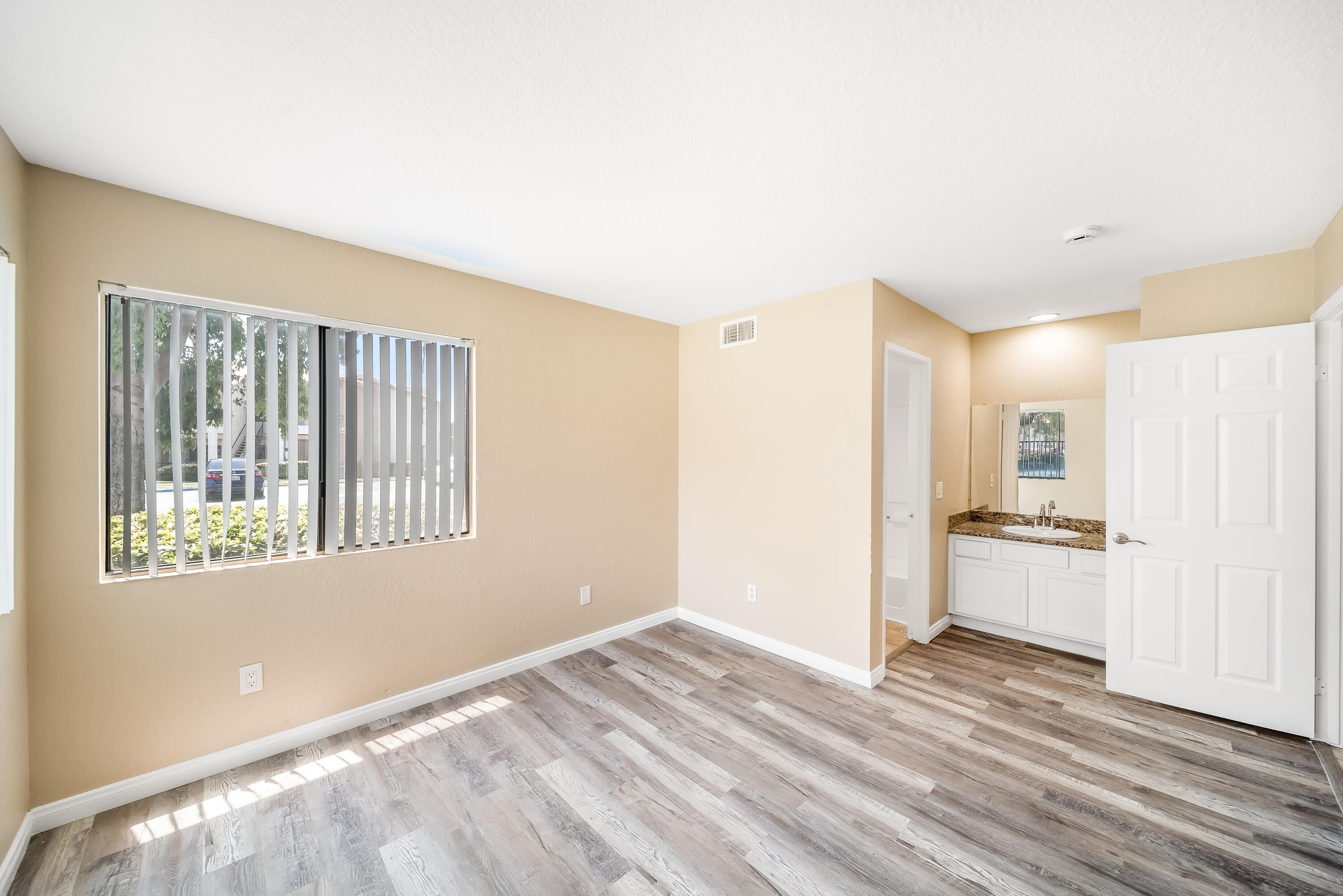 78650 Ave 42, Unit 1407 Bermuda Dunes, CA 92203 - Photo 16 of 20 a view of an empty room with a window and wooden floor