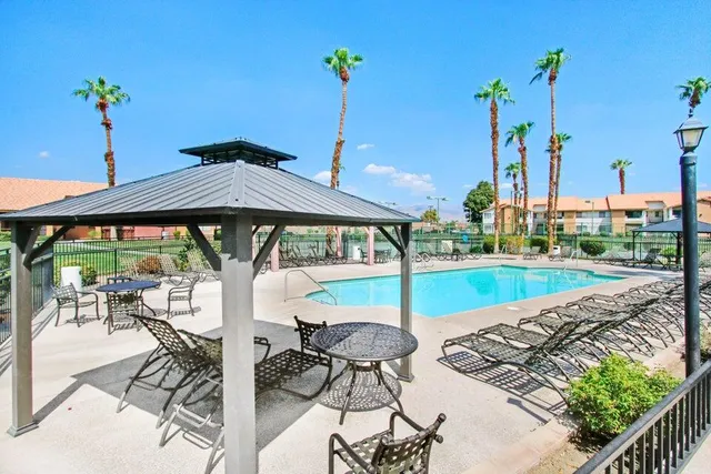 a view of a patio with a table chairs and a table