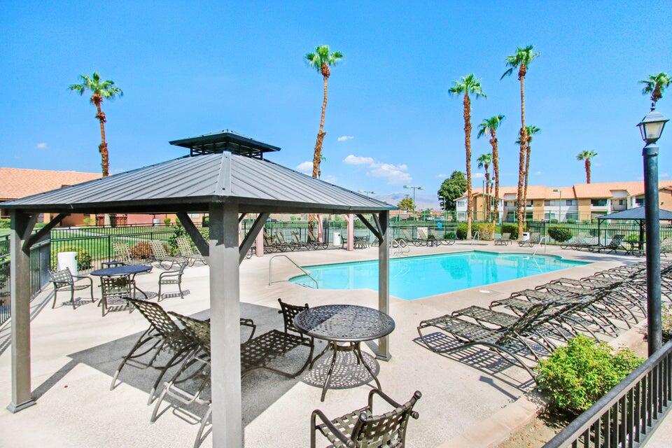 78650 Ave 42, Unit 1407 Bermuda Dunes, CA 92203 - Photo 3 of 20 a view of a patio with a table chairs and a table